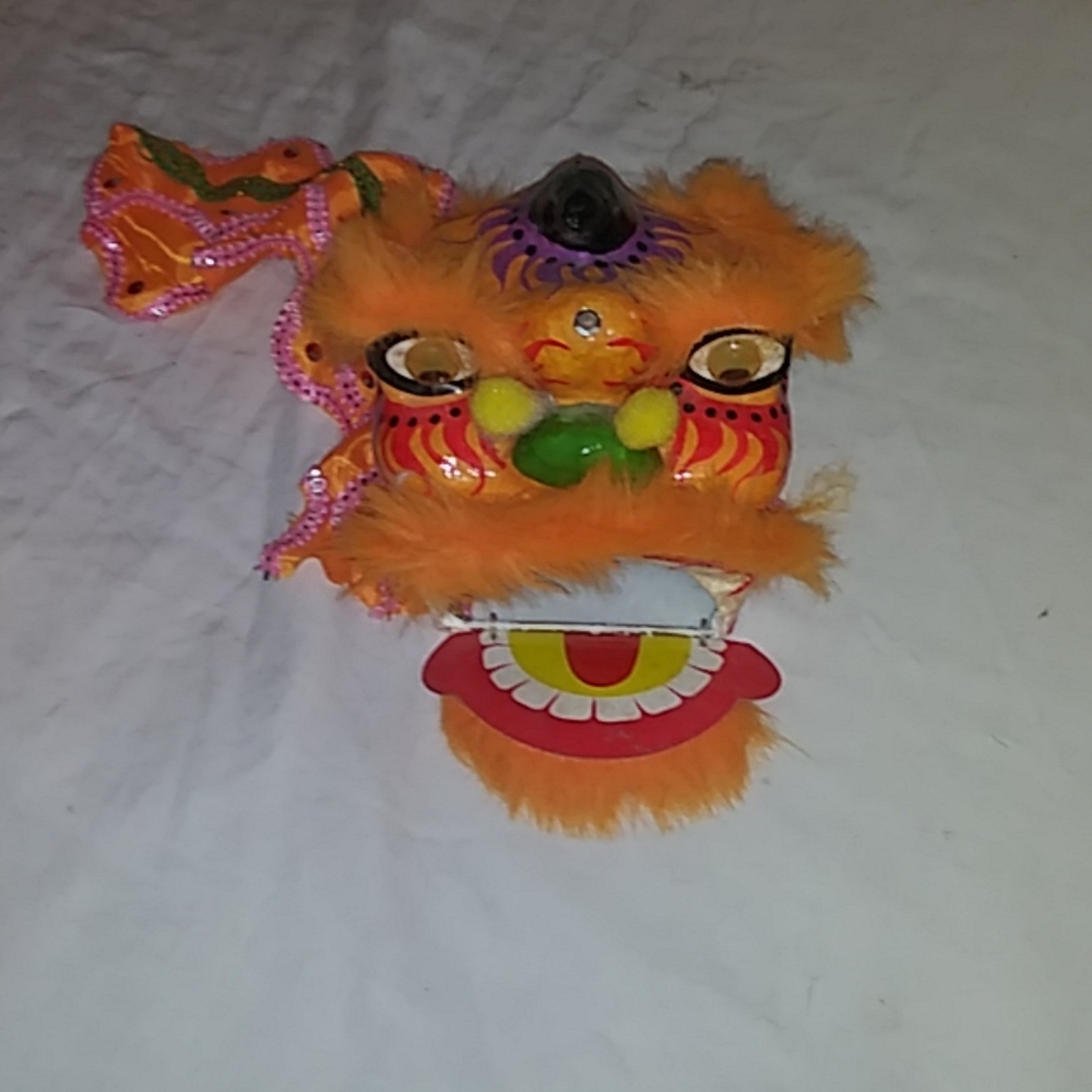 Chinese paper mache orange and purple dragon mask.